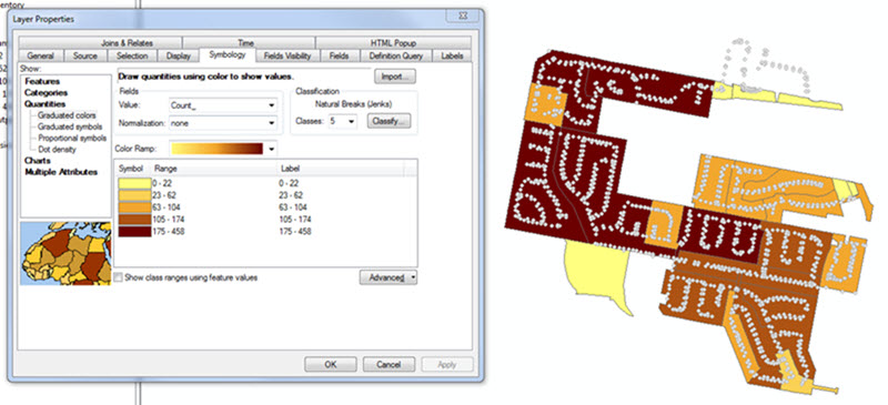 The Layer Properties window displaying the Symbology tab. Clicking Quantities displays the Graduated colors parameters. Next to the Layer Properties window, the polygon layer joined with the point layer are displayed.